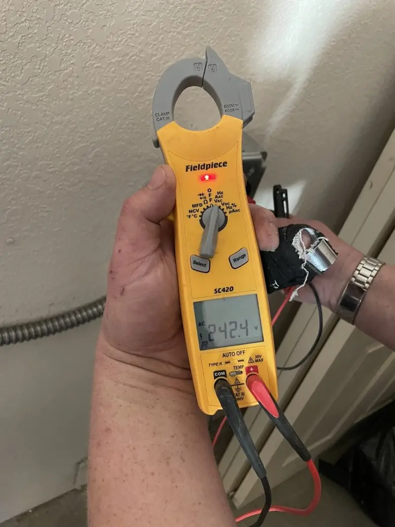 Voltage testing with clamp meter during Ceiling Fan Installation in Reserve
